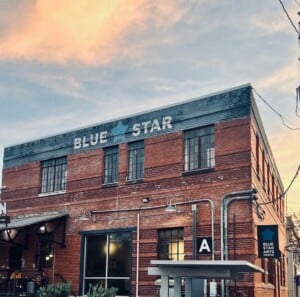 Blue Star Arts Complex brick building glowing at sunset in Southtown, San Antonio