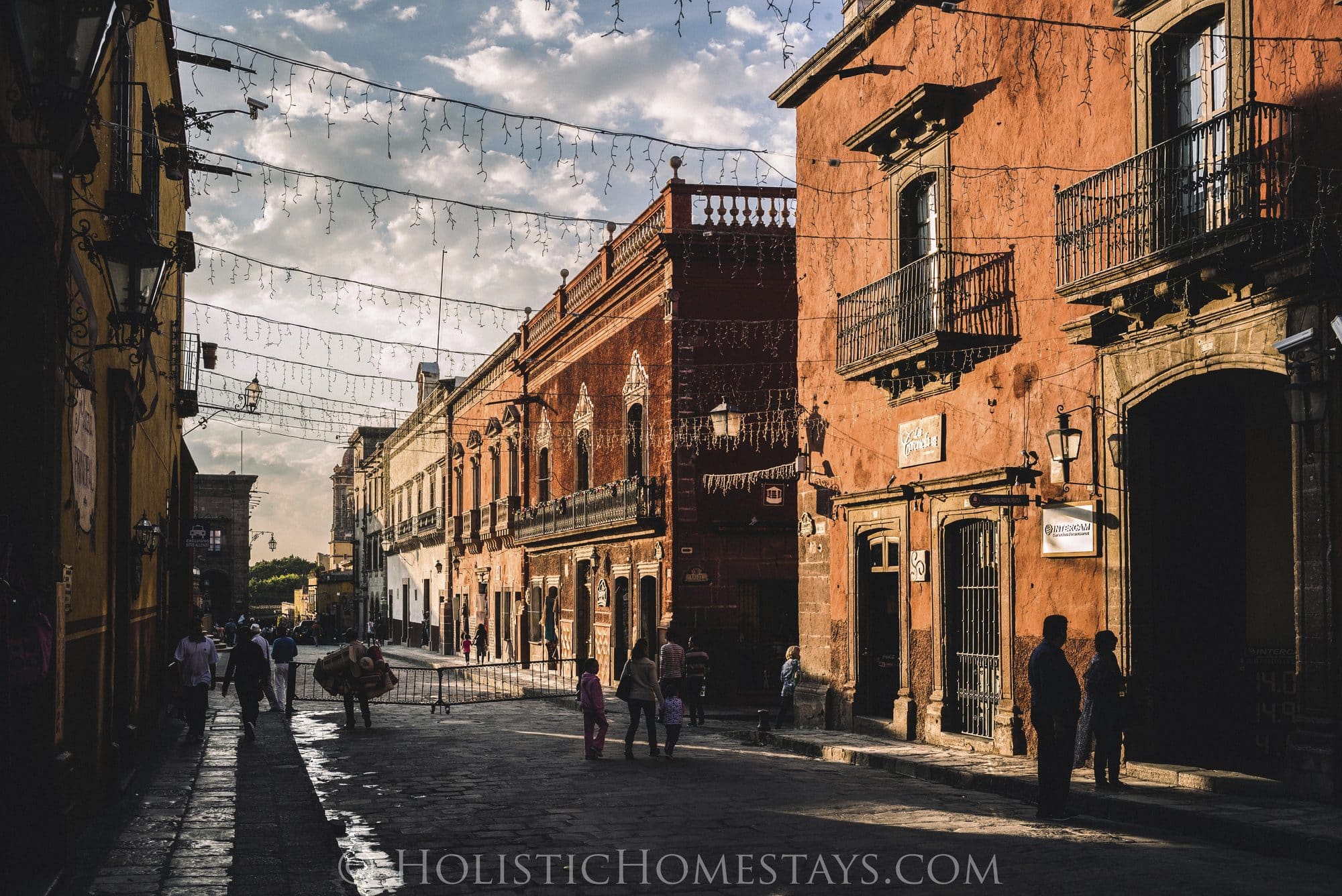 A quiet cobblestone street in centro San Miguel de Allende in warm golden-hour light