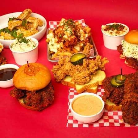 Spread of Nashville hot chicken sandwiches, tenders and sides at Pete's Hot Chicken, San Antonio