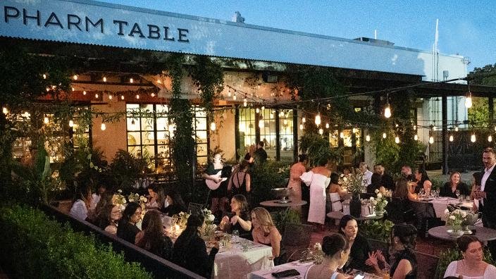 Diners on the string-lit garden patio at Pharm Table in Southtown, San Antonio at dusk