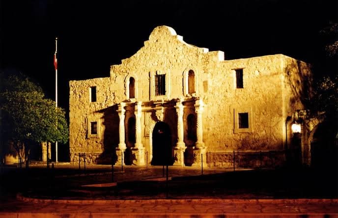 The Alamo illuminated against the night sky in downtown San Antonio