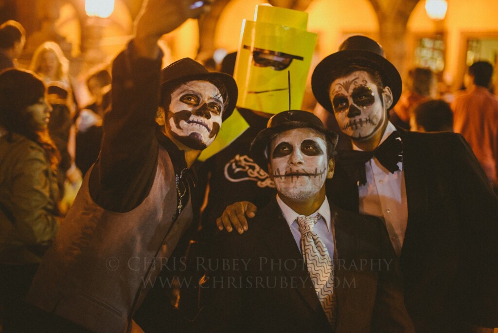 Three revelers in Catrín skull face paint and top hats in San Miguel de Allende