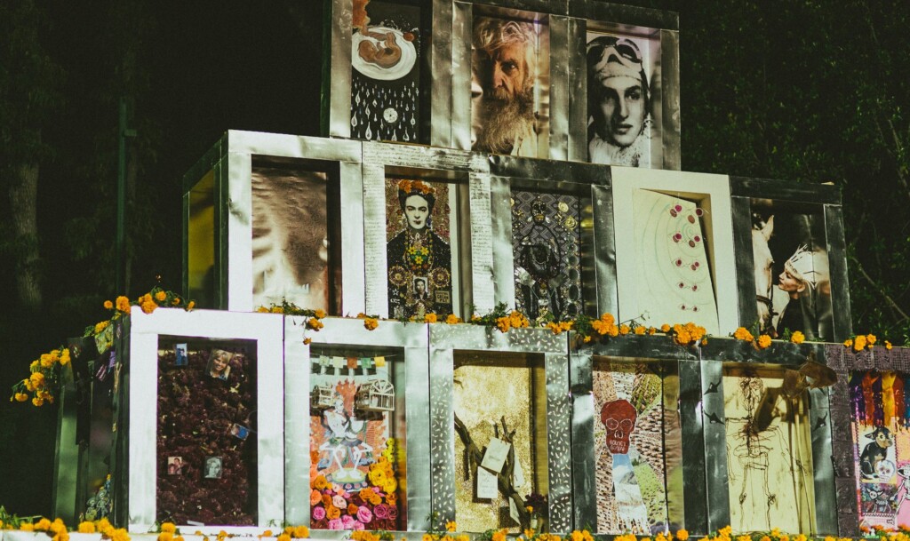 Community ofrenda of framed portraits surrounded by marigolds in San Miguel de Allende