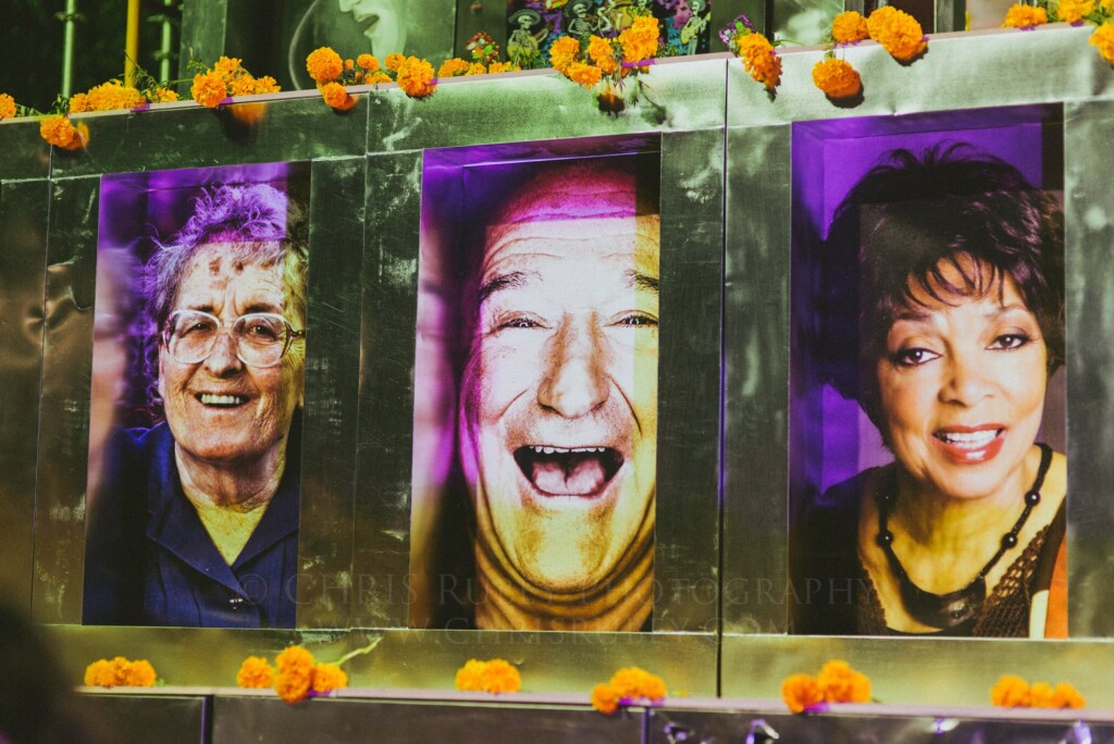 Altar of large illuminated portraits trimmed with marigolds for Día de Muertos in San Miguel de Allende