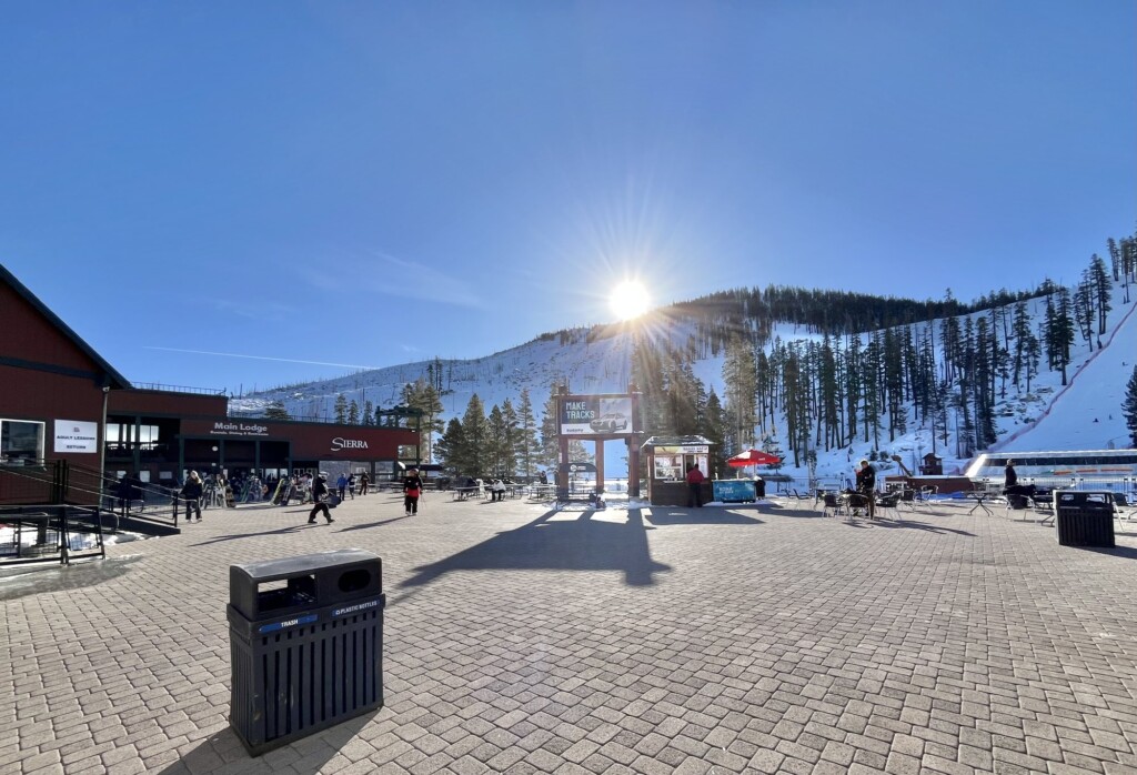 Sierra-at-Tahoe Mountain Resort sign and base lodge with snowy slopes behind