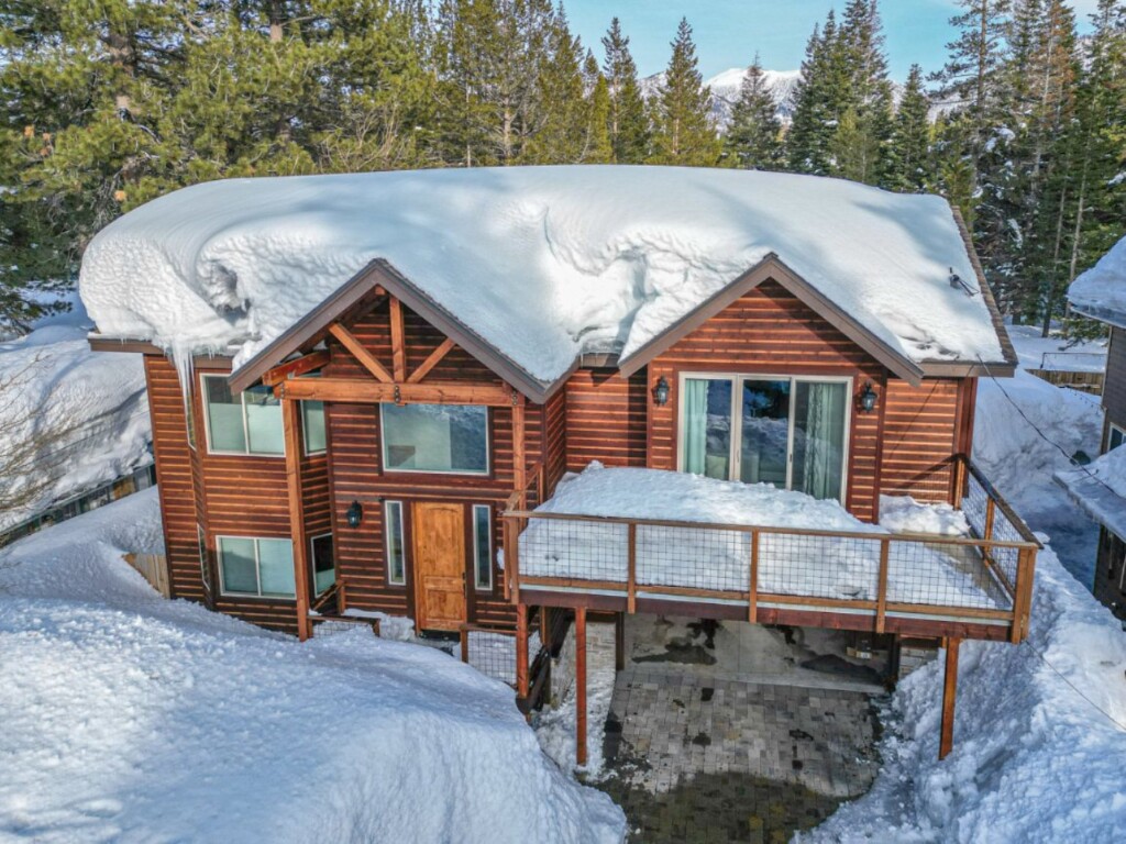 Holistic Homestays' wood chalet near Lake Baron in South Lake Tahoe covered in deep snow